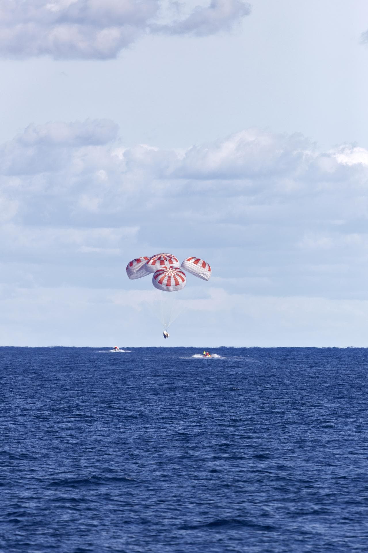 Crew Dragon under parachutes approaching splashdown in the Atlantic
