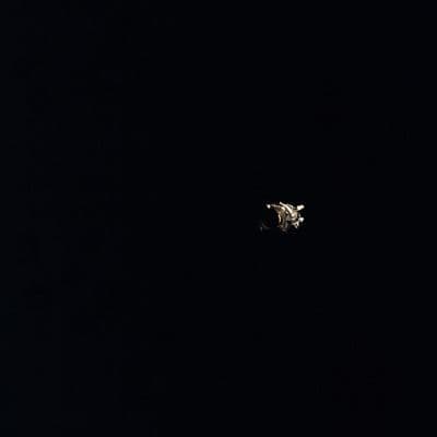 The damaged Apollo 13 service module photographed after separation, showing the panel blown off by the oxygen tank explosion (NASA AS13-59-8500).