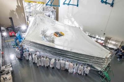 Engineers stack and unfurl a full-sized test unit of Webb's five-layer sunshield in a Northrop Grumman cleanroom in Redondo Beach, California.