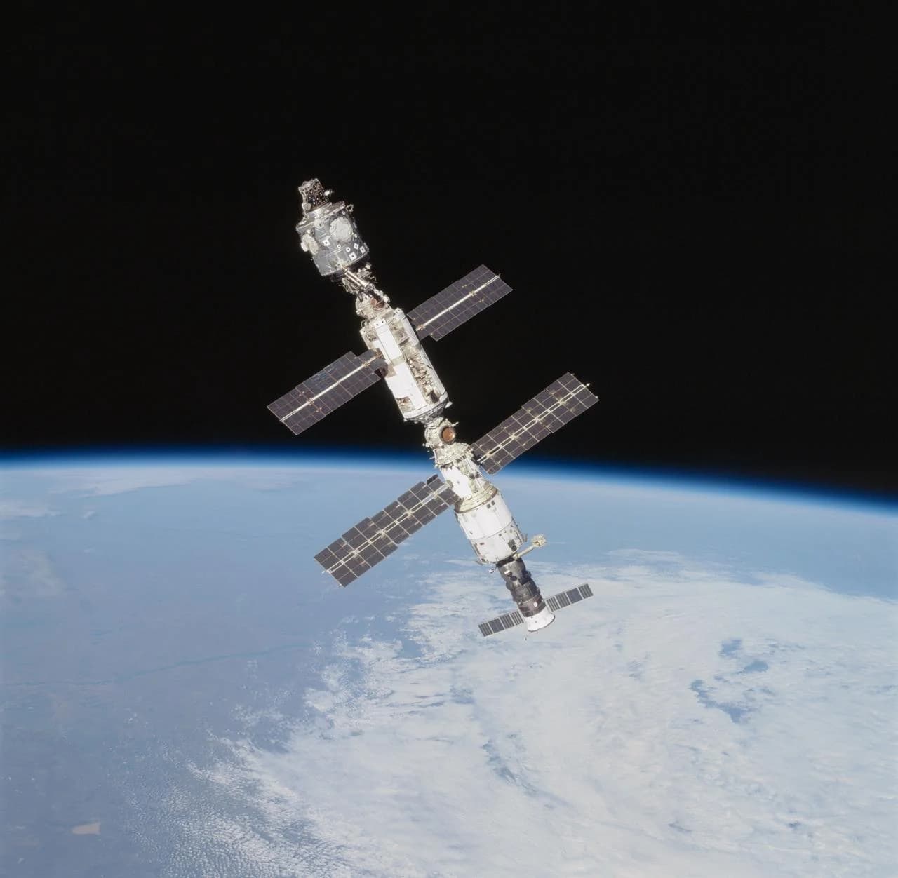 The International Space Station above Earth's horizon, photographed from Atlantis during STS-106 in September 2000. A spacecraft in orbit remains in free fall. NASA.