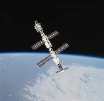 The International Space Station above Earth's horizon, photographed from Atlantis during STS-106 in September 2000. A spacecraft in orbit remains in free fall. NASA.