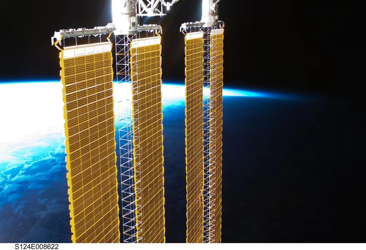 The ISS P4 and P6 solar arrays above Earth's horizon, photographed during STS-124 on 10 June 2008. Maintaining a station's orbit requires tracking and occasional corrections. NASA.