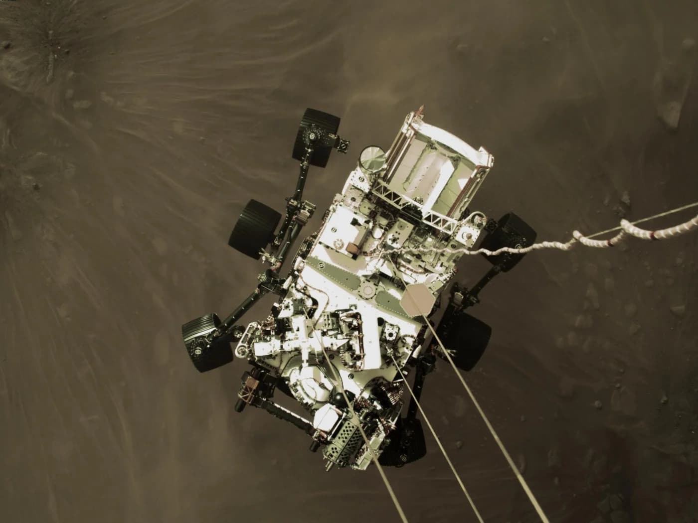 A camera on the descent stage captured Perseverance hanging on its cables moments before touchdown on 18 February 2021.