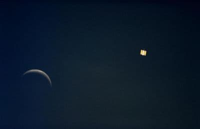 Onboard view from STS-61 of the Hubble Space Telescope and moon together