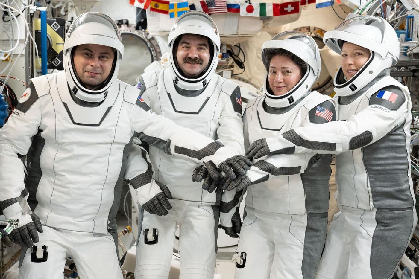 NASA's SpaceX Crew-12 members gather for a portrait in their Dragon pressure suits