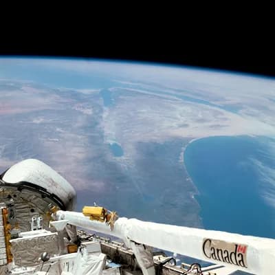 The Middle East photographed from Columbia during STS-3, with the robotic arm in the foreground.