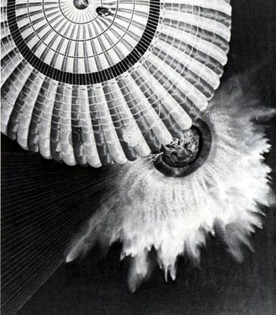 The Apollo 17 command module descends on three parachutes to splashdown in the Pacific Ocean, 19 December 1972.